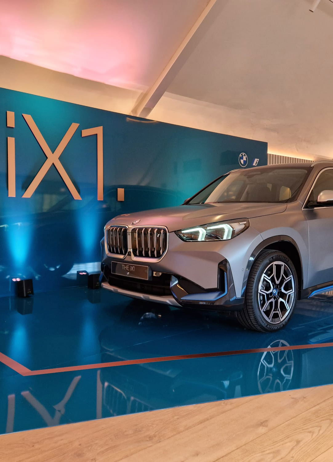 Bespoke stand with a car in a showroom.